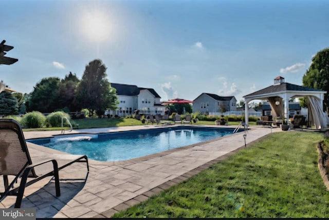 pool with a gazebo, a lawn, and a patio area