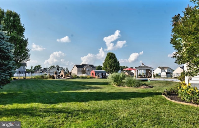 view of yard with a residential view, fence, and a gazebo