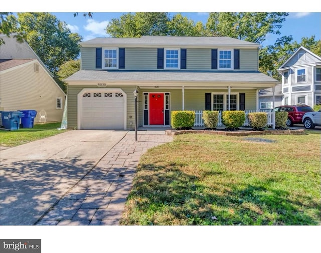 traditional-style home featuring a porch, a garage, driveway, and a front lawn