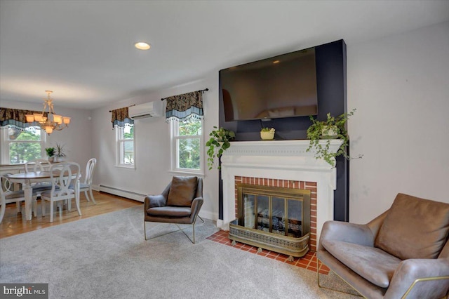 living room featuring a wall unit AC, a brick fireplace, a baseboard heating unit, a notable chandelier, and recessed lighting