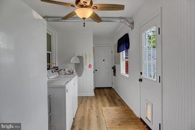 washroom with laundry area, light wood finished floors, baseboards, ceiling fan, and washer and dryer