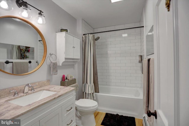 full bathroom with toilet, shower / bathtub combination with curtain, wood finished floors, and vanity