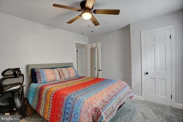 carpeted bedroom with ceiling fan and baseboards