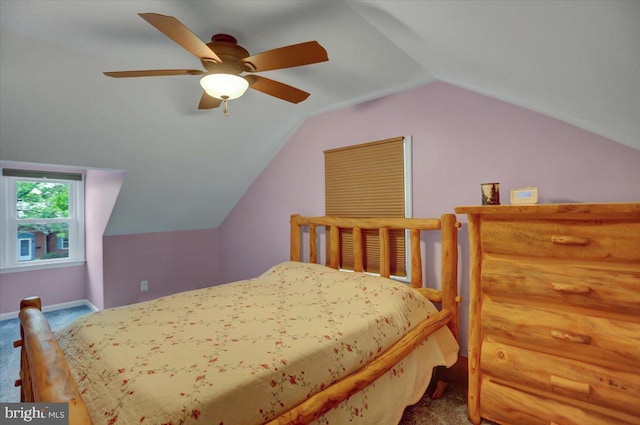 carpeted bedroom featuring ceiling fan, baseboards, and vaulted ceiling