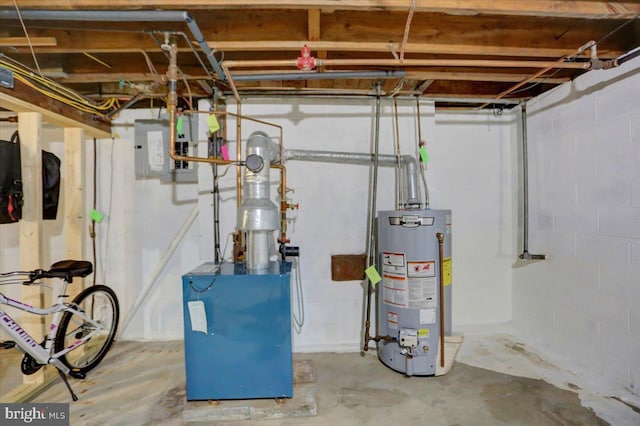 utility room featuring gas water heater, electric panel, and a heating unit