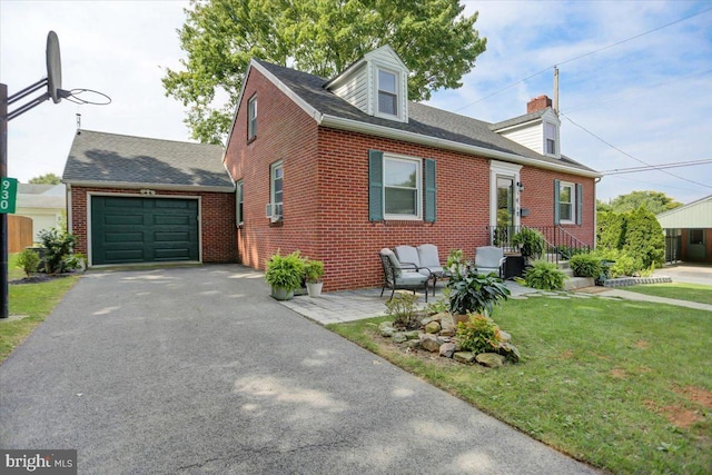 cape cod home featuring a front lawn, brick siding, driveway, and an attached garage