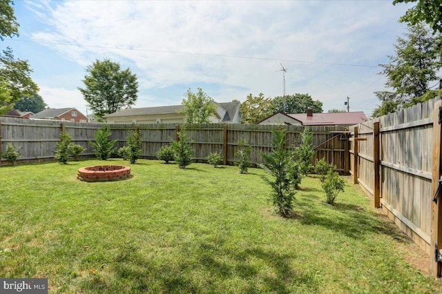 view of yard featuring an outdoor fire pit and a fenced backyard