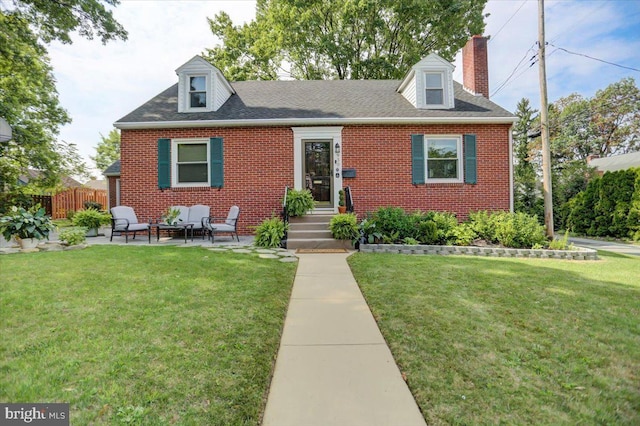 cape cod-style house with a front yard, brick siding, fence, and a chimney