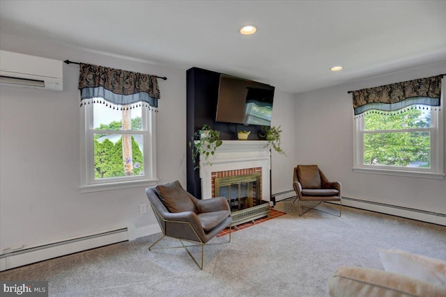 sitting room featuring a brick fireplace, a baseboard radiator, an AC wall unit, and recessed lighting