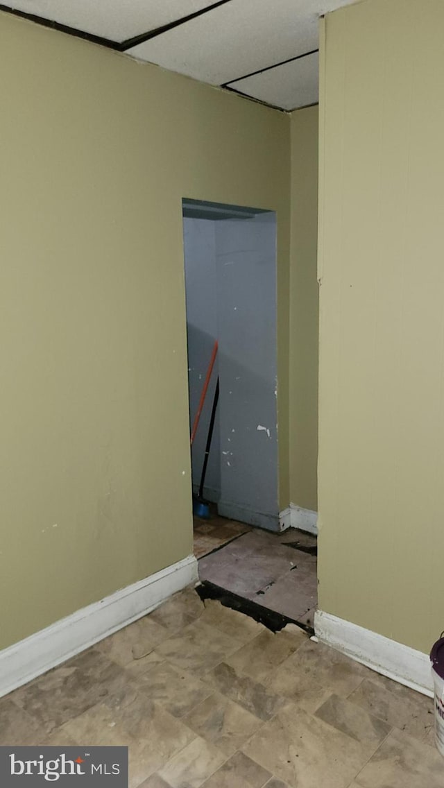 unfurnished room with baseboards