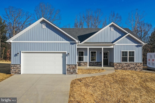 modern farmhouse style home with an attached garage, board and batten siding, and concrete driveway