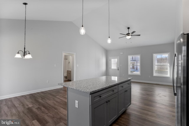 kitchen with dark wood-style floors, ceiling fan with notable chandelier, open floor plan, and freestanding refrigerator