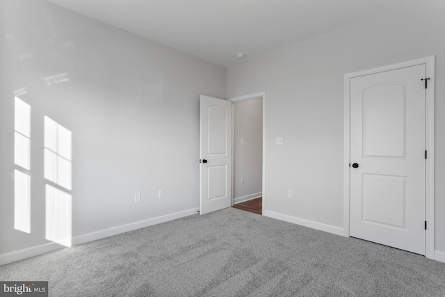 unfurnished bedroom with carpet and baseboards