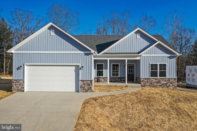 modern farmhouse style home with a shingled roof, a porch, an attached garage, board and batten siding, and driveway