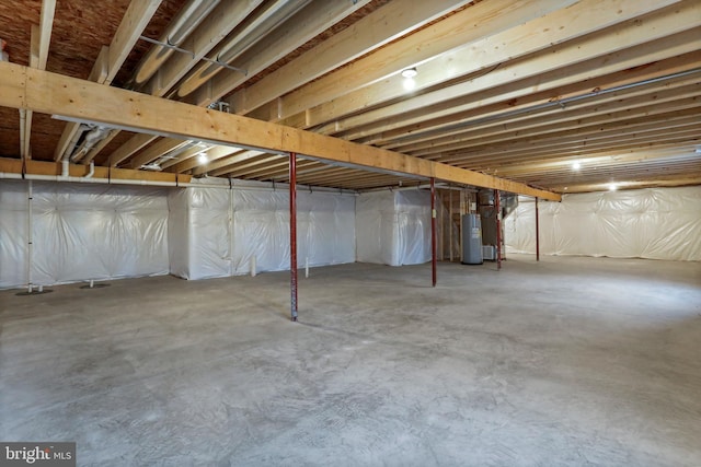 unfinished basement featuring water heater