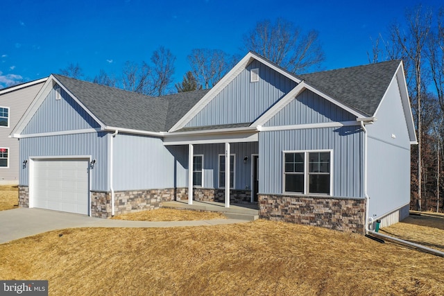 modern farmhouse with stone siding, roof with shingles, driveway, and an attached garage