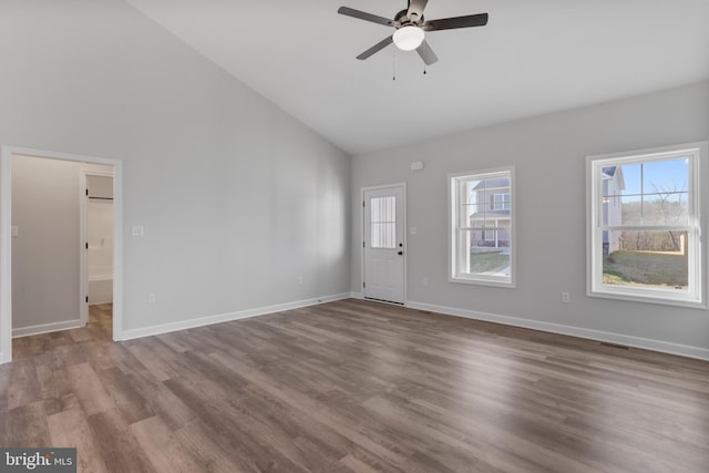 interior space featuring high vaulted ceiling, ceiling fan, baseboards, and wood finished floors