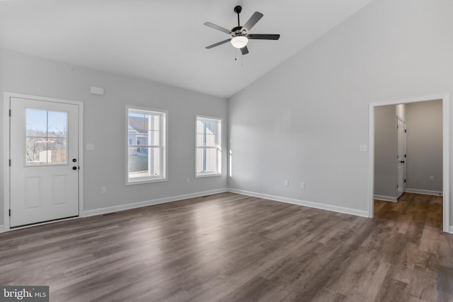 unfurnished living room featuring dark wood-style floors, ceiling fan, high vaulted ceiling, and baseboards