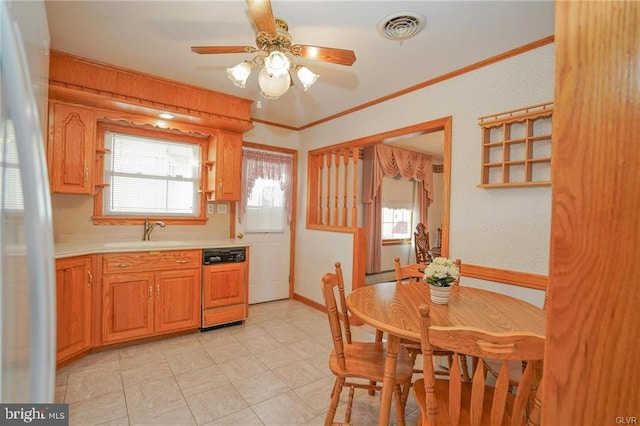 kitchen with light countertops, visible vents, paneled dishwasher, ornamental molding, and a sink