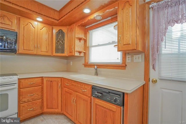 kitchen with light countertops, paneled dishwasher, a sink, black microwave, and range