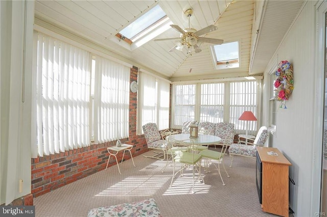 sunroom with lofted ceiling with skylight and ceiling fan