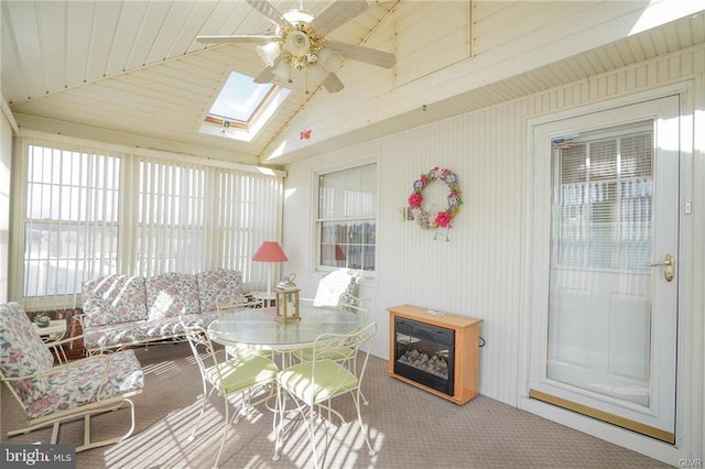 sunroom with ceiling fan and lofted ceiling with skylight