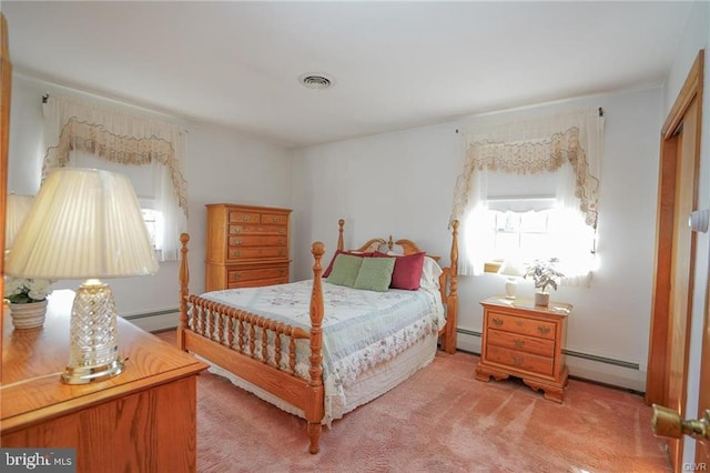 bedroom featuring a baseboard radiator, visible vents, and light carpet