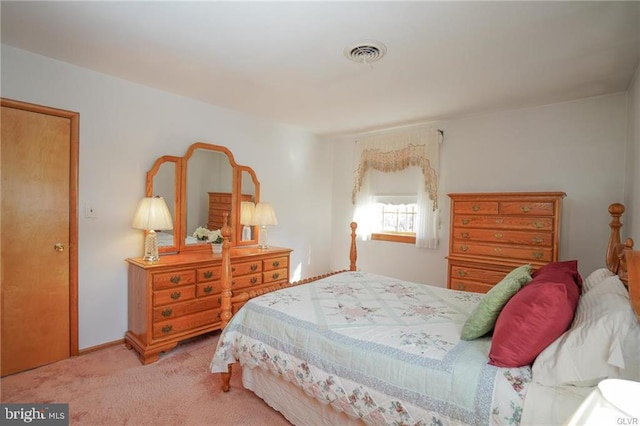 carpeted bedroom featuring visible vents