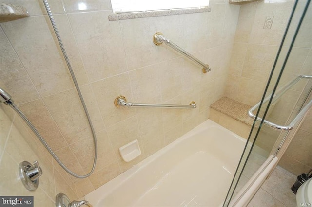 bathroom featuring shower / bath combination with glass door