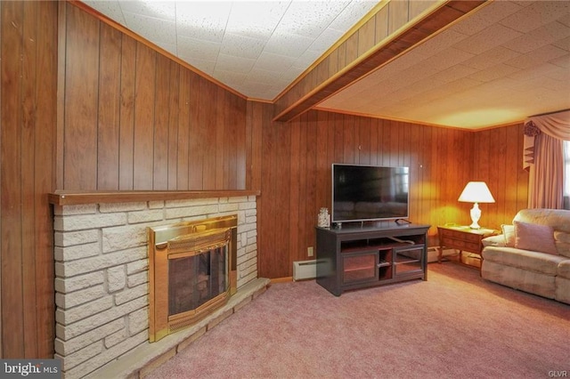 living room featuring carpet floors, wood walls, a fireplace, and a baseboard radiator