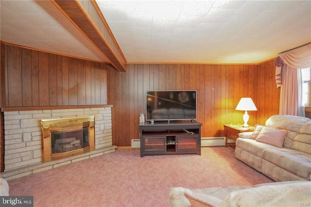 carpeted living area featuring wood walls, baseboard heating, and a stone fireplace