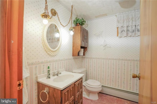 half bath featuring a baseboard radiator, vanity, toilet, and wallpapered walls