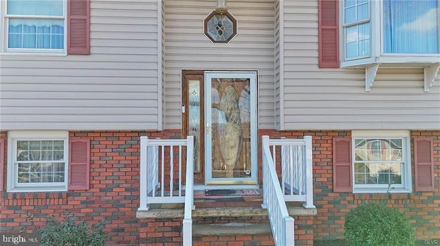 entrance to property with brick siding