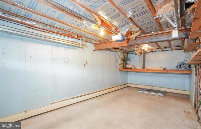 unfinished basement featuring a baseboard heating unit