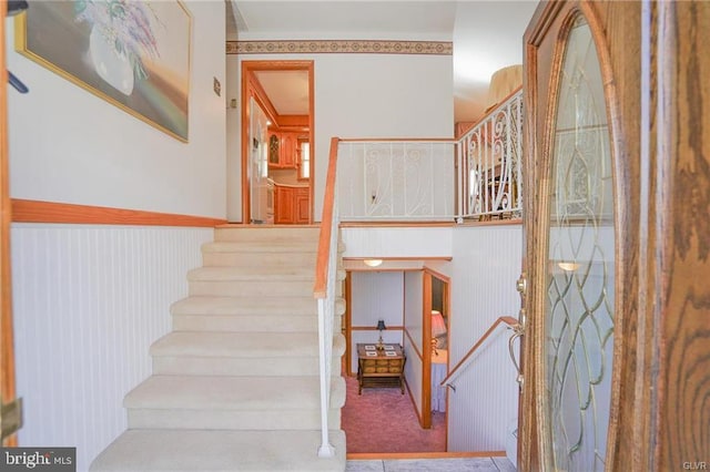 staircase featuring carpet