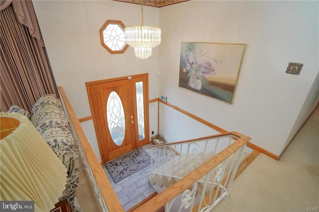 entrance foyer featuring stairway and a chandelier