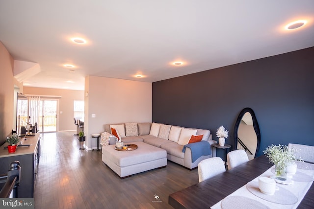 living room featuring dark wood-style floors and baseboards