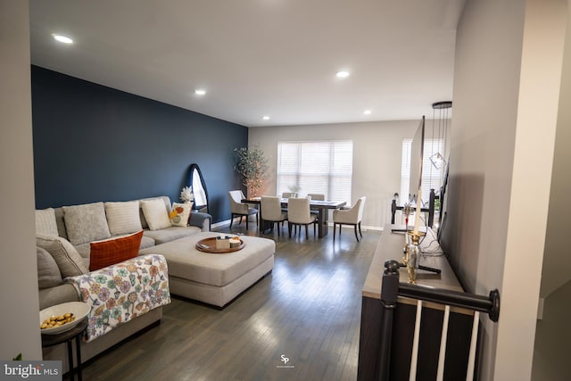 living area with recessed lighting, baseboards, and dark wood-type flooring