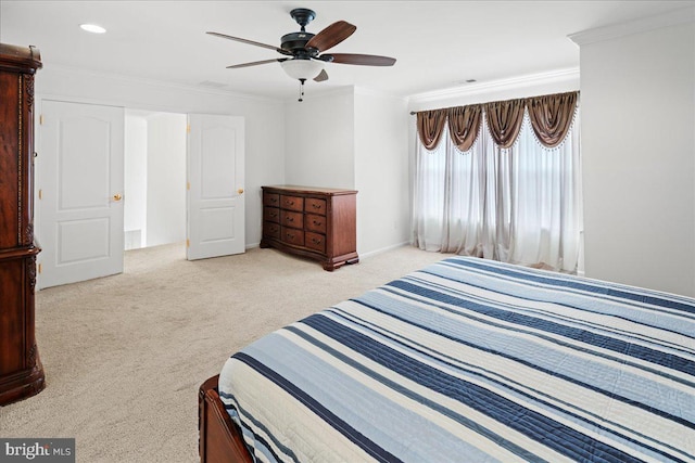 carpeted bedroom featuring visible vents, crown molding, and ceiling fan