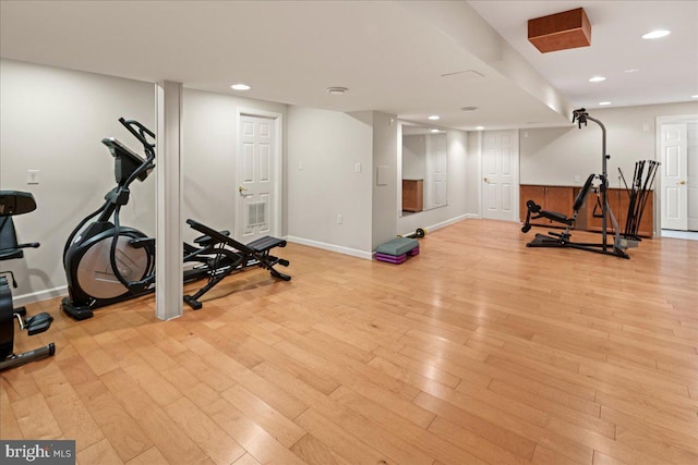 workout area with recessed lighting, baseboards, and light wood-style flooring