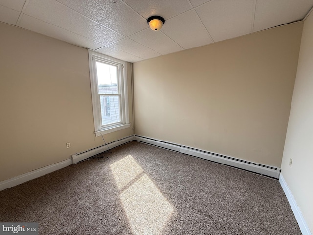 carpeted spare room featuring baseboards