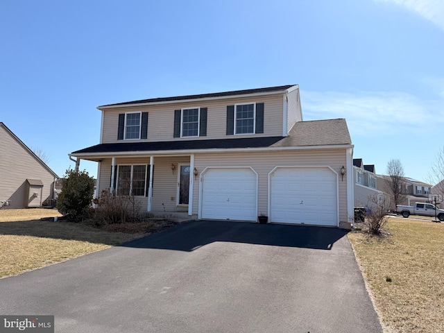 traditional home featuring driveway and a front lawn