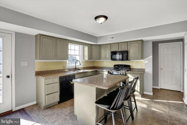 kitchen with black appliances, gray cabinets, visible vents, and a sink