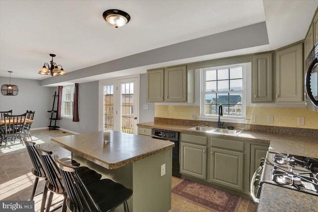 kitchen featuring a sink, black dishwasher, dark countertops, a center island, and gas range