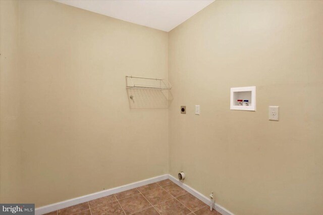 laundry room with baseboards, laundry area, electric dryer hookup, washer hookup, and tile patterned flooring