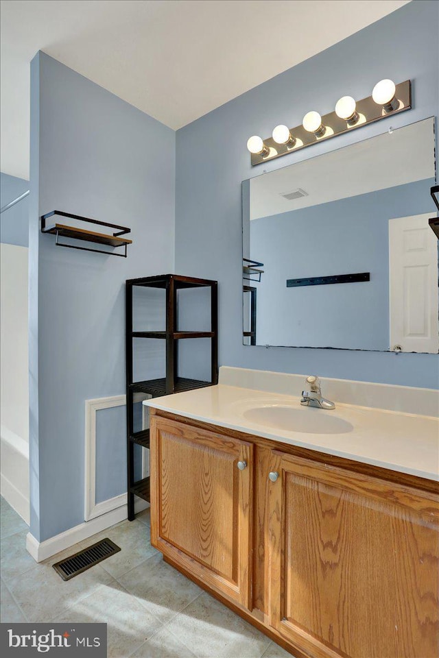 bathroom with vanity, tile patterned floors, baseboards, and visible vents