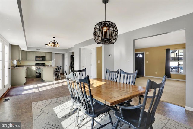 dining room featuring light tile patterned floors, visible vents, baseboards, and an inviting chandelier