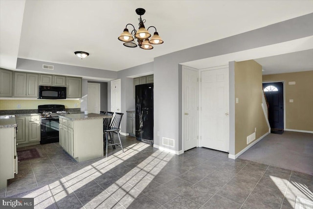 kitchen with visible vents, baseboards, and black appliances