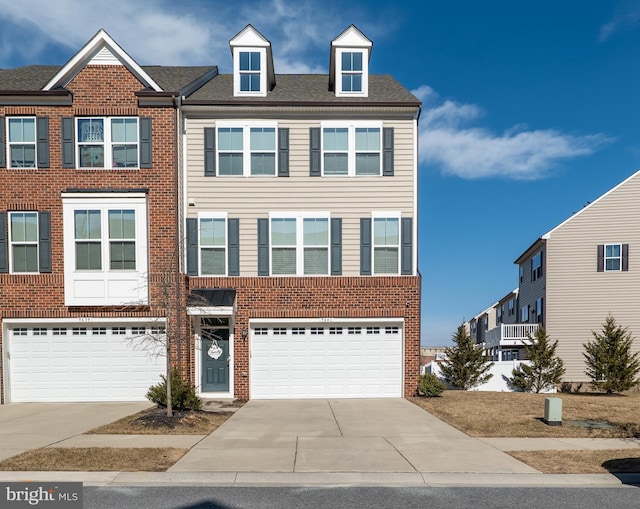 multi unit property featuring a garage, driveway, brick siding, and a shingled roof