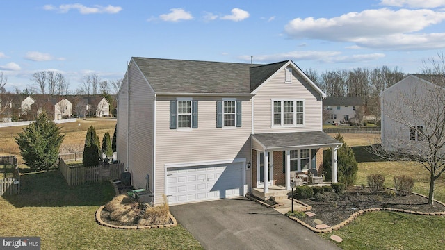 traditional home with a garage, aphalt driveway, fence, and a porch